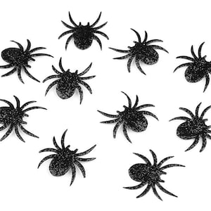 Könnte beinhalten: Zehn schwarze Glitzer-Spinnen mit jeweils acht Beinen. Die Spinnen sind auf einem weißen Hintergrund verstreut.