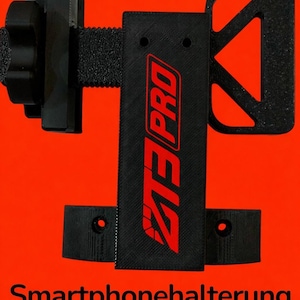 May include: Black smartphone holder with red "ZT3 PRO" logo and the text "Smartphonehalterung" on an orange background. The holder has adjustable components and the word "NEW" repeated at the top.