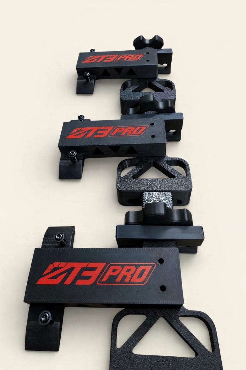 May include: A vertical arrangement of black metal brackets with the red text "Z3 PRO". The brackets have various shapes and sizes, including triangular and rectangular designs. The image is taken against a light beige background.