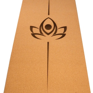 May include: A brown cork yoga mat with a black lotus flower design and the text "Tranquil Yoga" in the bottom right corner.