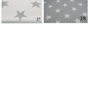 May include: Two fabric swatches with a white star pattern on a gray background. The swatch on the left is white with gray stars. The swatch on the right is gray with white stars. The swatches are labeled 27 and 28.
