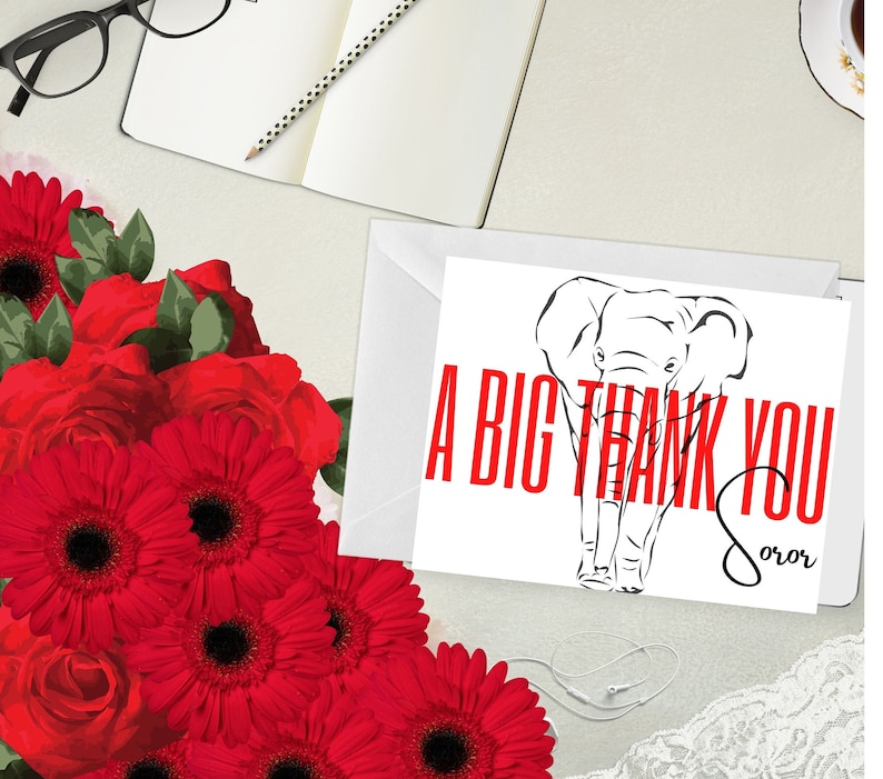 May include: A white thank you card with a black elephant illustration and red text that reads "A BIG THANK YOU Soror". The card is on a white envelope, with a bouquet of red flowers and a notebook in the background.