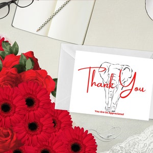 May include: A white card with red text reading "Thank You" and an elephant outline. The words "You Are So Appreciated" are below. Red flowers and a white envelope are also visible in the image.