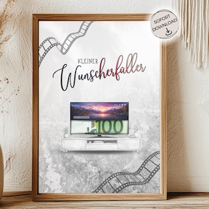 Könnte beinhalten: Gerahmter Druck mit einem Fernseher, der einen Sonnenuntergang über einem See und einen 100-Dollar-Schein zeigt. Der Druck enthält den Text "Kleiner Wunscherfüller" und Filmstreifen-Grafiken. Ein "SOFORT DOWNLOAD"-Aufkleber ist vorhanden. Holzrahmen.