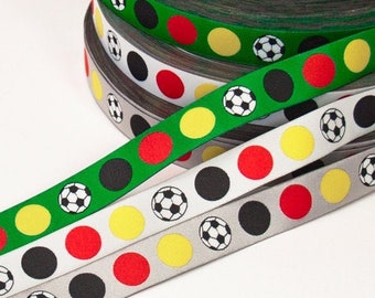 Football dots black/red/gold on white, grey, green ribbon