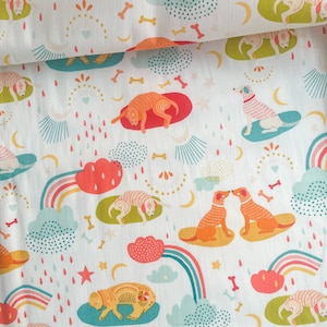 May include: White fabric with a repeating pattern of orange and yellow dogs, rainbows, clouds, and stars. The dogs are in various poses, including sleeping, running, and sitting. The clouds are in shades of blue and pink, and the rainbows are multi-colored.
