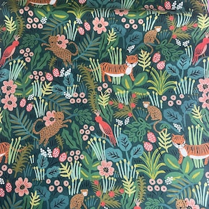 May include: A dark green fabric featuring a repeating pattern of tigers, leopards, monkeys, and pink birds amidst lush foliage, including various green leaves, stems, and small pink and white flowers scattered throughout the dense jungle design.