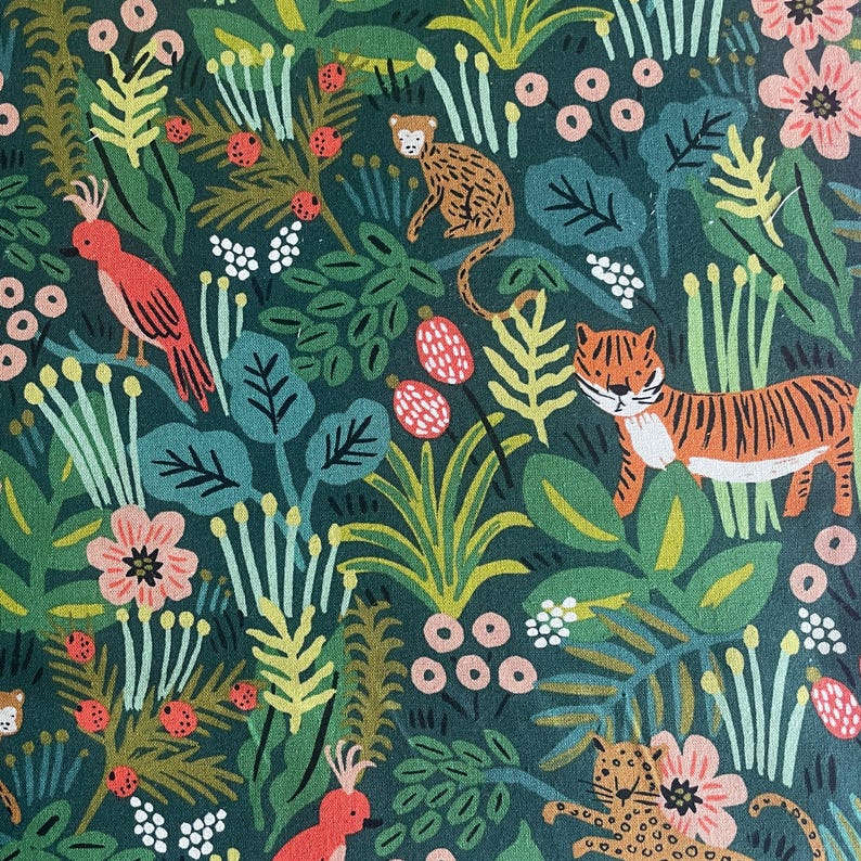 May include: A dark green fabric featuring a repeating pattern of jungle animals including a tiger, a leopard, and a red bird. The design includes various botanical elements such as light green leaves, pink flowers, and small red berries throughout.