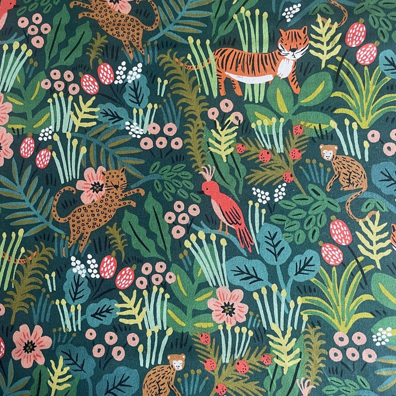May include: A dark green fabric featuring a repeating pattern of orange tigers, spotted leopards, monkeys, and pink birds nestled among stylized foliage, ferns, and clusters of small pink and white berries throughout the dense jungle scene.