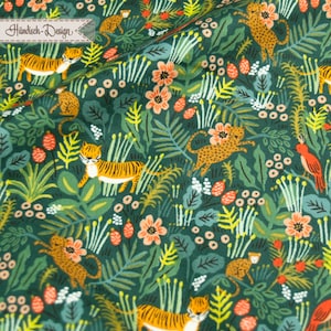 May include: A green fabric with a repeating pattern of tigers, monkeys, birds, and flowers. The fabric has a dark green background with orange, yellow, red, and white accents.