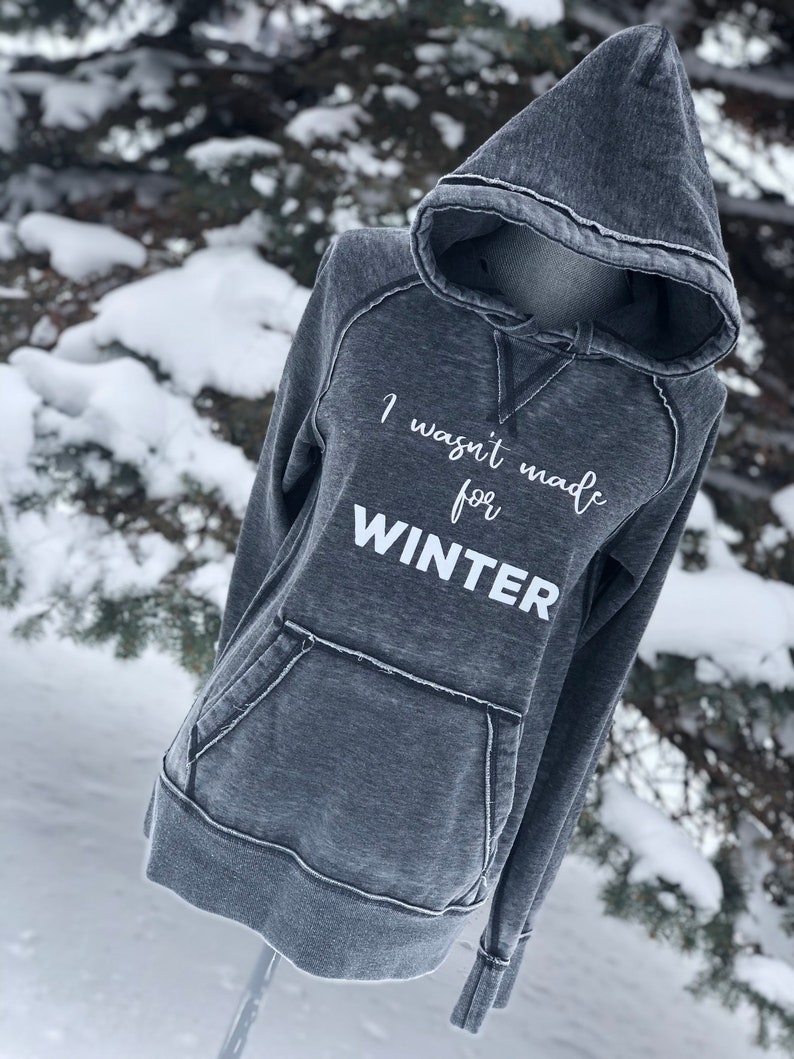 May include: A gray hooded sweatshirt with the text "I wasn't made for WINTER" printed in white on the front.