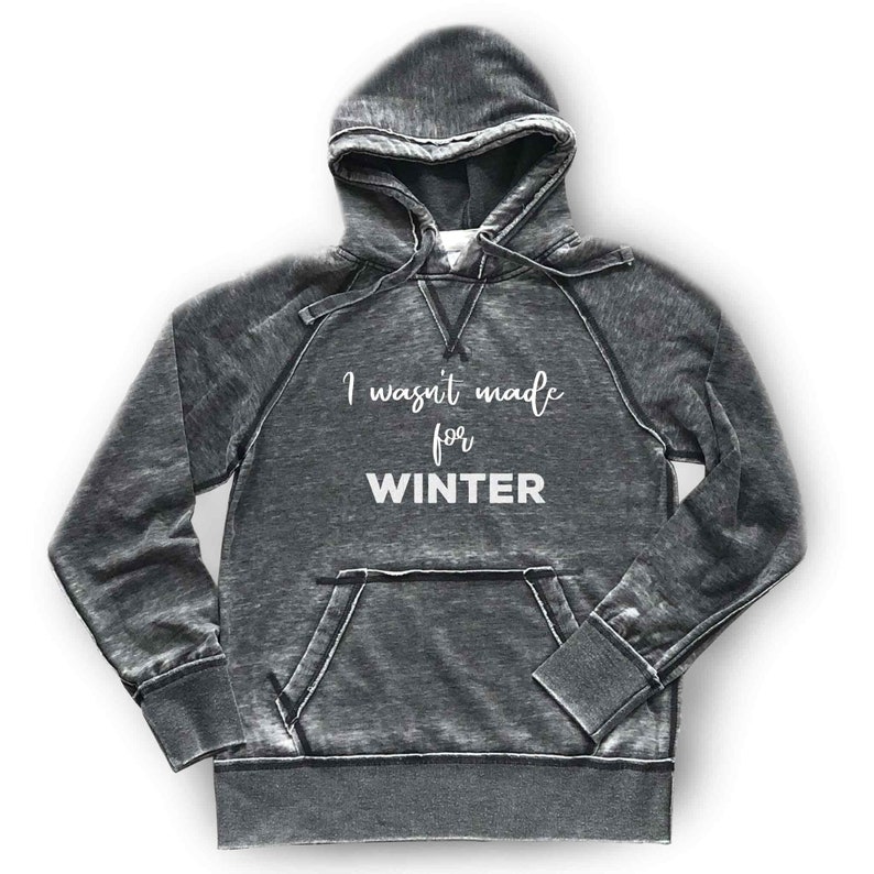 May include: A gray hooded sweatshirt with a distressed look. The text "I wasn't made for WINTER" is printed in white on the front.