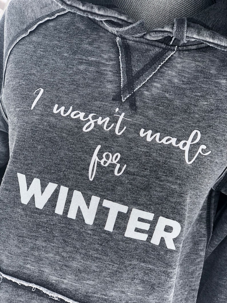 May include: A gray hooded sweatshirt with the text "I wasn't made for WINTER" printed in white.
