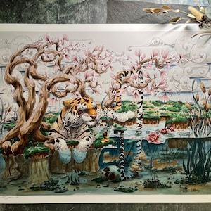 May include: Watercolor illustration of a tiger in a serene landscape with a pond, blooming trees, and clouds. The artwork features a detailed depiction of the tiger, water lilies, and lush greenery, creating a tranquil scene.