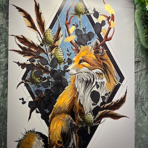 May include: A digital illustration of a fox with antlers made of branches and leaves. The fox is sitting in a diamond-shaped frame surrounded by foliage. The background is a blue and white watercolor wash.