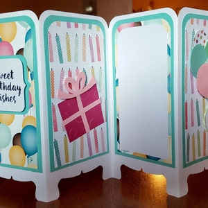 May include: A three-panel card with a teal border and a white background. The front panel has a balloon pattern and the text "sweet birthday wishes". The middle panel has a pattern of colorful candles and a pink gift box with a bow. The back panel has a blank white space.