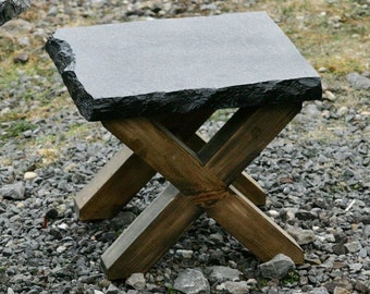 Small slate topped coffee table with smooth edges and solid wood legs