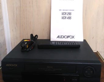 Vintage Audiovox VCR 295 videokassettbandspelare från 1990-talet, fjärrkontroll och bruksanvisning