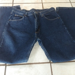 May include: A pair of dark blue denim jeans with a straight leg fit.