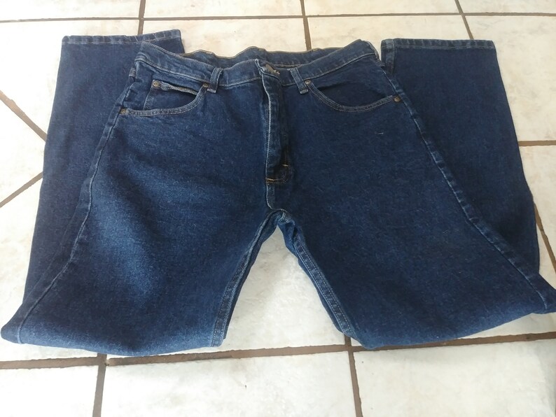 May include: A pair of dark blue denim jeans with a straight leg fit.
