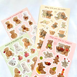 May include: Four sticker sheets with teddy bear designs. The stickers show bears in different poses, some with flowers or fruit. The sheets have text that says "Have a Fluffy Day", "Why are you so cute?" and "Why are you so sweet?"