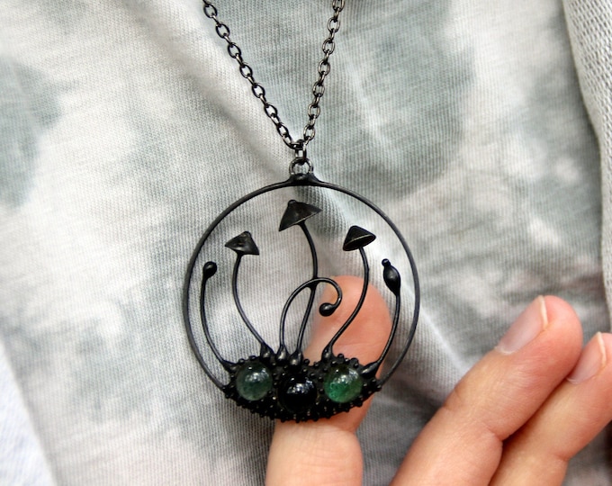 Psylocybe magic mushrooms handmade round metal black pendant with green glass, wild nature festival rave clothing, woodland shrooms jewelry.