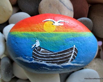Evening mood, decorative stone boat on the beach, stone art, painted stones, boat on stone,