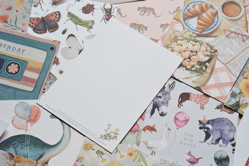 K&ouml;nnte beinhalten: Eine Sammlung von bunten gemusterten Papieren mit Illustrationen von Schmetterlingen, Insekten, Tieren und Blumen. Die Papiere eignen sich perfekt zum Scrapbooking, Kartenbasteln und anderen Bastelprojekten.