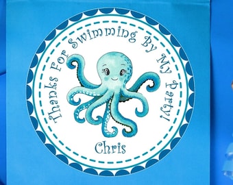 May include: A blue party favor bag with a circular sticker featuring a teal octopus illustration. The sticker reads "Thanks For Swimming By My Party!" and includes the name "Chris". Decorative blue ribbon is also present.