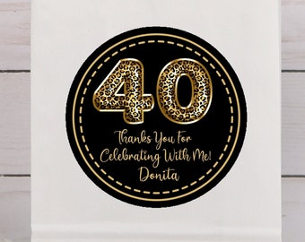May include: White paper gift bag with a round sticker featuring the number 40 in a leopard print design. The sticker also includes the text "Thanks You For Celebrating With Me! Donita". The bag has a white handle.