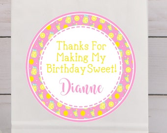 May include: White paper gift bag with a pink and yellow lemon-themed sticker that says "Thanks For Making My Birthday Sweet! Dianne".