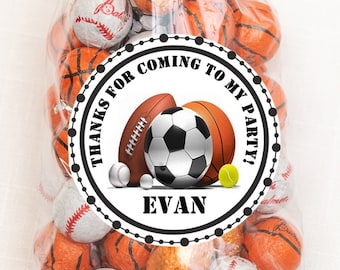 May include: A white circle sticker with black text and images of sports balls. The text reads "Thanks for coming to my party!" and "Evan".