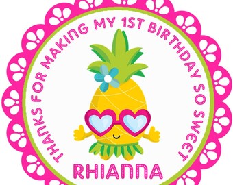 May include: A round sticker with a cartoon pineapple wearing heart-shaped sunglasses. The sticker has a pink scalloped border and green and white inner circles. Text reads "THANKS FOR MAKING MY 1ST BIRTHDAY SO SWEET" and "RHIANNA".