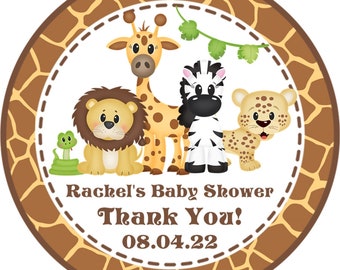 May include: Round sticker with a brown giraffe, zebra, lion, and leopard on a white background with a brown giraffe print border. The text "Rachel's Baby Shower Thank You! 08.04.22" is printed on the sticker.