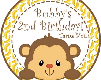 May include: A circular sticker with a cartoon monkey and the text "Bobby's 2nd Birthday! Thank You." The border is brown with a pattern of yellow bananas. The monkey has brown fur, a tan face, and is smiling.