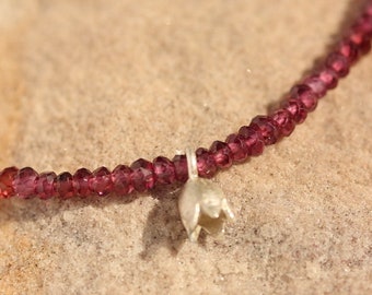 Garnet necklace made of faceted grant beads with silver blossom