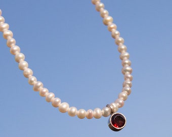 Freshwater pearl necklace with garnet pendant set in silver