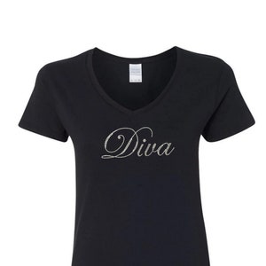 May include: Black v-neck t-shirt with the word "Diva" in silver glitter lettering.