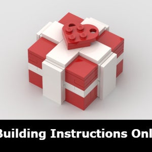 May include: A small red and white gift box with a white ribbon and a red heart on top. The box is made of LEGO bricks.