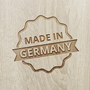 May include: A wooden sign with a wavy border, reading "Made in Germany".