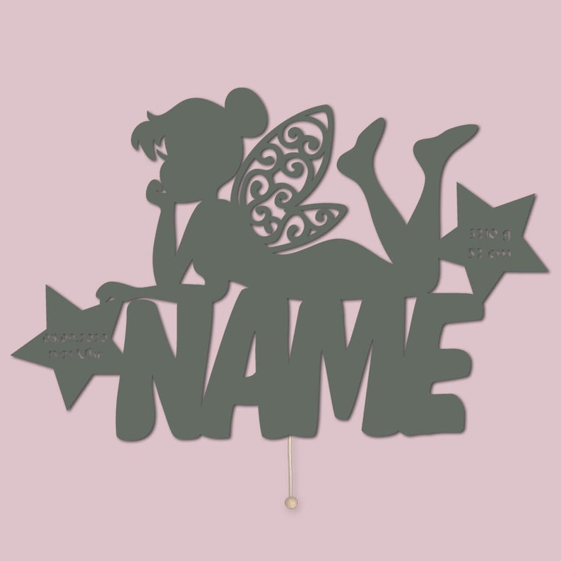 May include: A green wooden fairy silhouette with wings and a star, with the name "NAME" written below. The fairy is lying on her side, with her head resting on her hand. The star has the words "Do you believe in fairy dust?" written on it.