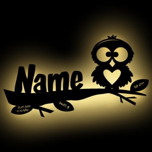 May include: Black silhouette of an owl with a heart on its chest, perched on a branch with the word "Name" and the date "22.07.2021 17:32 Uhr" and the text "3402 g" and "50 cm" on the branch.