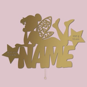 May include: Gold-colored fairy silhouette with wings, holding a star with the text "NAME" and the inscription "3210 g 52 cm" on the right side.