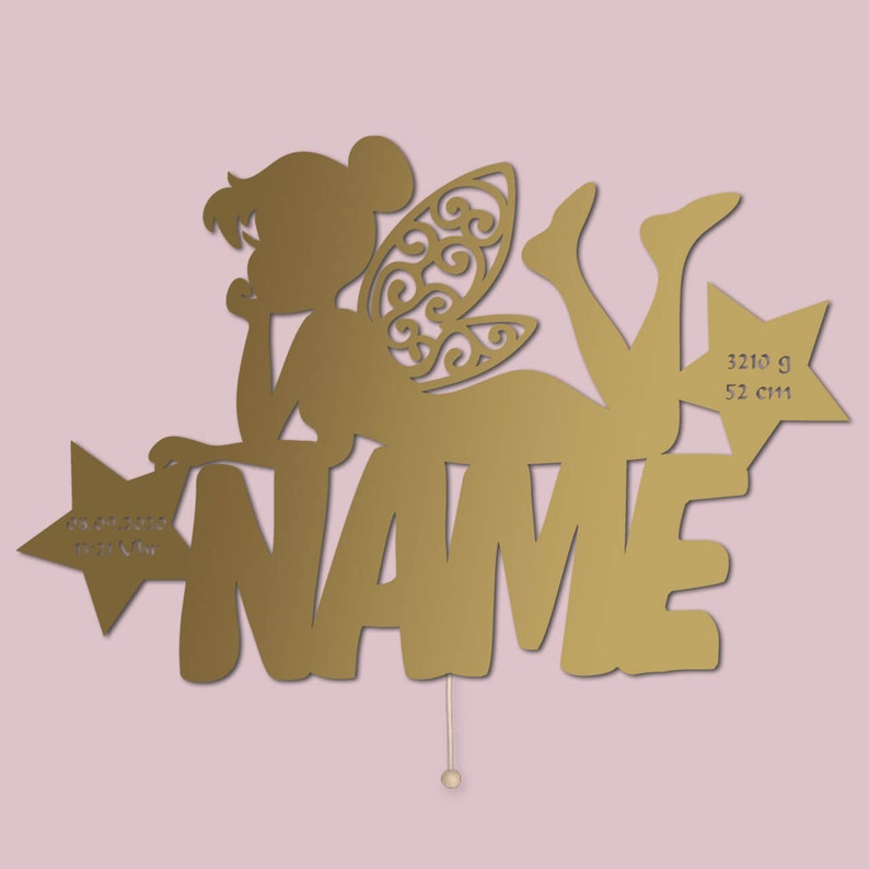 May include: Gold-colored fairy silhouette with wings, holding a star with the text "NAME" and the inscription "3210 g 52 cm" on the right side.