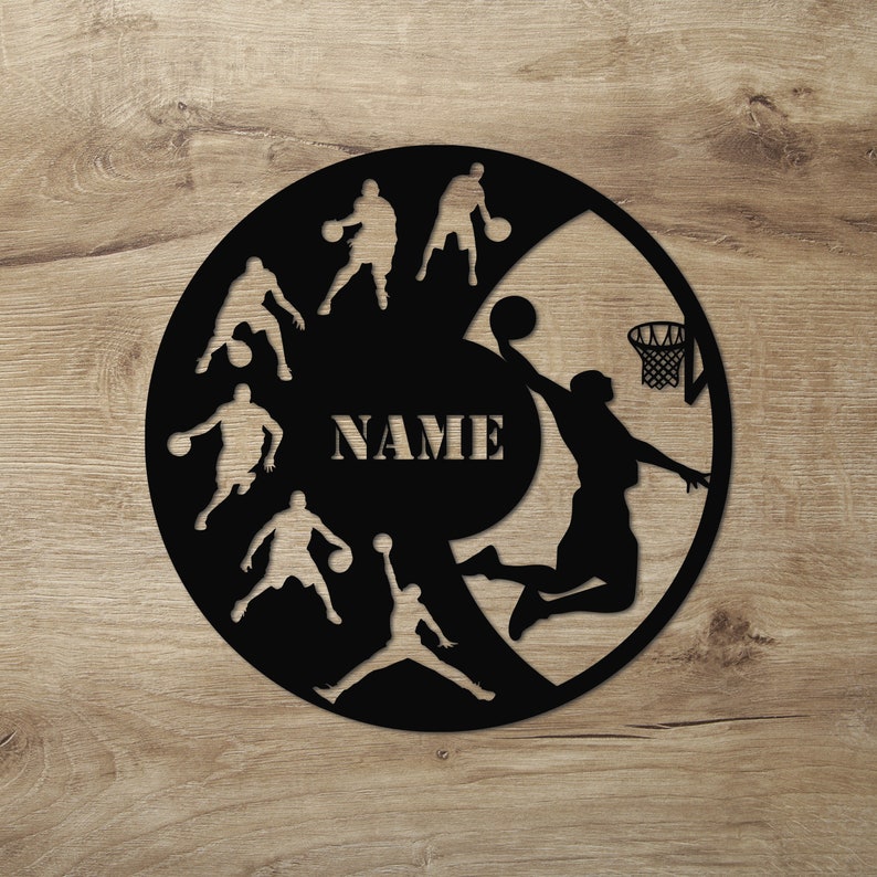 May include: Black and white silhouette of basketball players on a round wooden sign with the word "NAME" in the center.