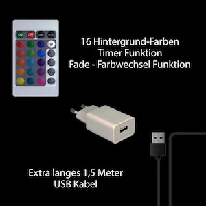 Könnte beinhalten: Eine weiße Fernbedienung mit 16 Farboptionen, einer Timerfunktion und einer Fade-Funktion. Die Fernbedienung befindet sich neben einem weißen Netzteil mit einem USB-Kabel. Der Text auf der Fernbedienung lautet "16 Hintergrund-Farben Timer Funktion Fade - Farbwechsel Funktion". Der Text unter dem Bild lautet "Extra langes 1,5 Meter USB Kabel".