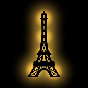 Op de afbeelding: Een zwart silhouet van de Eiffeltoren tegen een gele gloed.