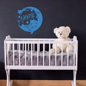 May include: Blue wooden baby name sign with a crescent moon, stars, and a teddy bear. The sign includes the text "NAME", "22.06.2021", "10:17 Uhr", "3995 g", and "53 cm".