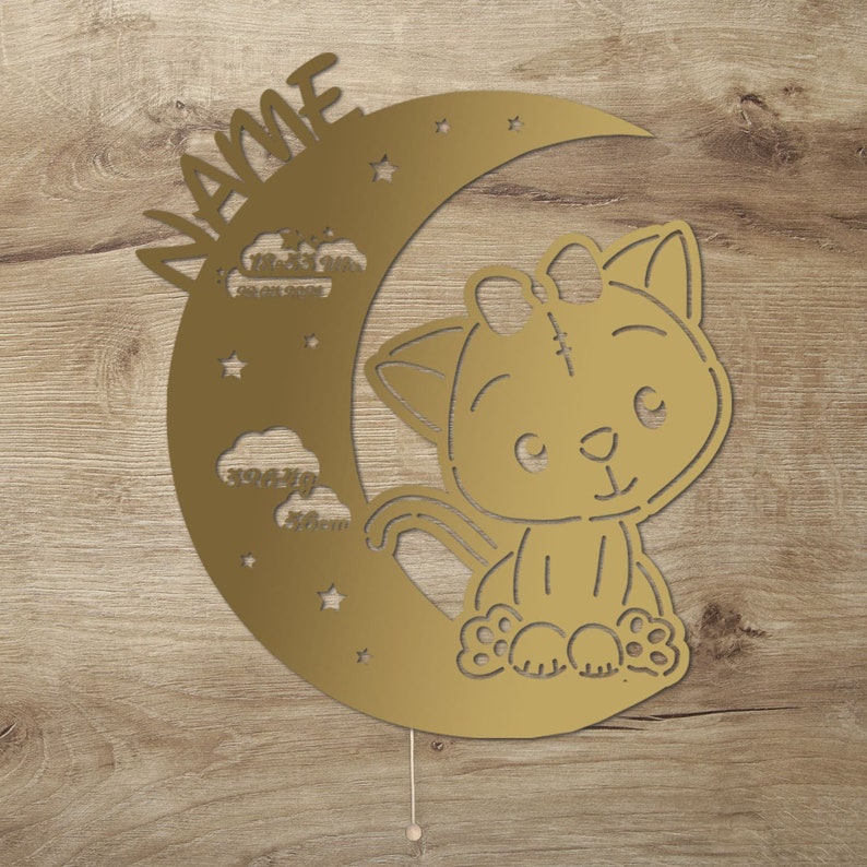 May include: Gold metal cutout of a crescent moon with a cute cat sitting on it. The moon has stars and clouds with measurements in inches. The cat has a bow on its head. The text "NAME" is written on the moon.
