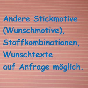 May include: A light pink fabric with thin white horizontal stripes featuring blue text that reads: Andere Stickmotive (Wunschmotive), Stoffkombinationen, Wunschtexte auf Anfrage m&ouml;glich.